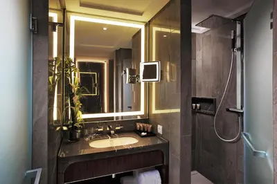 a bathroom with a sink and a mirror at Tangla Hotel Brussels in Brussels