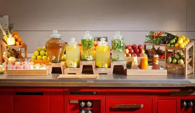 a counter with many bottles of juice and fruit at Tangla Hotel Brussels in Brussels