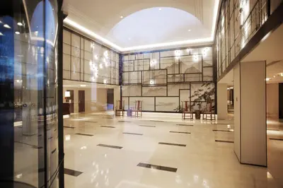 a large lobby with a large glass wall at Tangla Hotel Brussels in Brussels