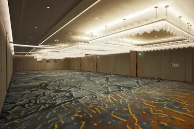 a large room with a dance floor with chandeliers at Tangla Hotel Brussels in Brussels