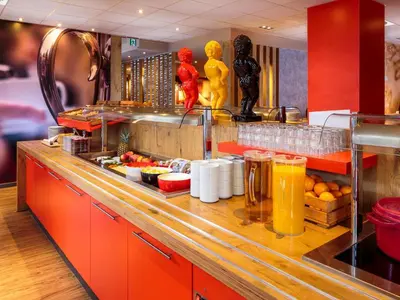 a kitchen with a counter with food and drinks at Ibis Brussels City Centre in Brussels