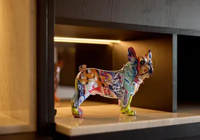 a colorful toy dog is sitting on a shelf at Cardo Brussels, Autograph Collection in Brussels