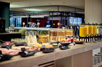 a buffet with food and drinks on a table at Cardo Brussels, Autograph Collection in Brussels