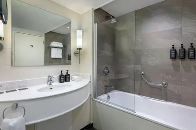 a bathroom with a sink and a shower at Sheraton Brussels Airport Hotel in Zaventem