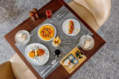 a tray with plates of food on a table at Sheraton Brussels Airport Hotel in Zaventem