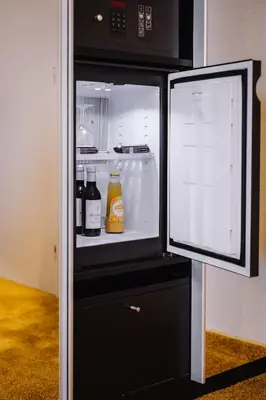 an open refrigerator with drinks inside of it at Holiday Inn Hotel Brussels Airport by IHG in Diegem