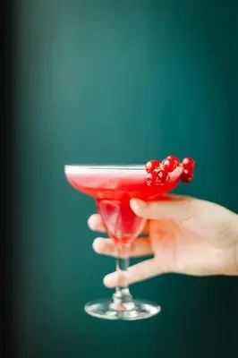 a hand holding a glass with a red drink at Holiday Inn Hotel Brussels Airport by IHG in Diegem