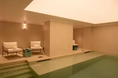 a waiting room with two chairs and a table at 9Hotel Chelton in Brussels