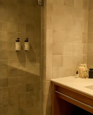 a bathroom with a shower and a sink at 9Hotel Chelton in Brussels