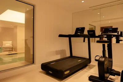 a room with a gym with a mirror and a treadmill at 9Hotel Chelton in Brussels