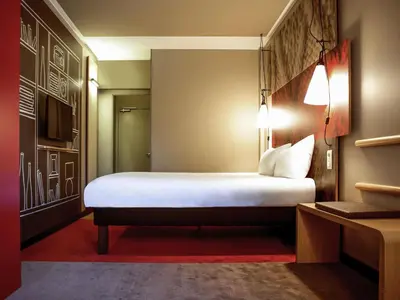a bedroom with a large white bed in a room at ibis Hotel Brussels off Grand'Place in Brussels