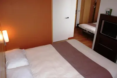 a hotel room with a bed and a television at ibis Hotel Brussels Expo Atomium in Brussels