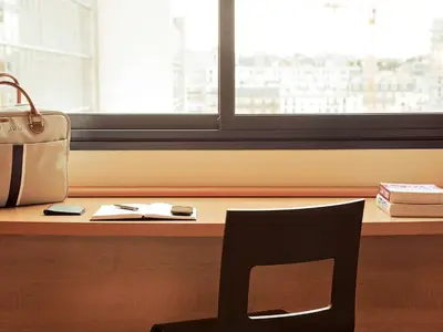 a chair sitting in front of a desk with a window at ibis Hotel Brussels Expo Atomium in Brussels
