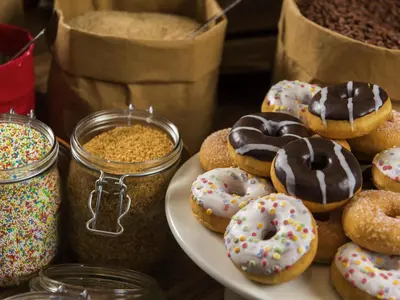 a plate of donuts on a table with other food at ibis Hotel Brussels Airport in Diegem