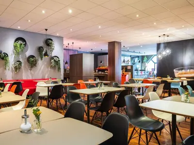 a restaurant with tables and chairs in a room at ibis Gent Centrum Opera in Ghent