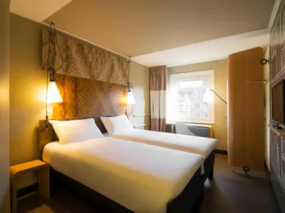 a hotel room with two beds and a window at ibis Gent Centrum Opera in Ghent