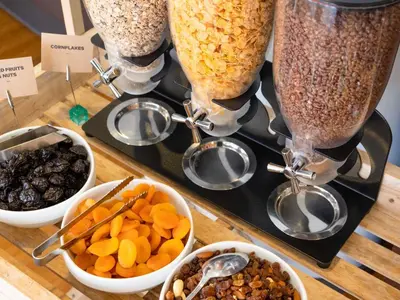 a table with bowls of cereal and other snacks at ibis Leuven Centrum in Leuven
