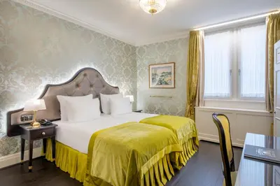 a hotel room with a bed with a yellow blanket at Stanhope Hotel by Thon Hotels in Brussels
