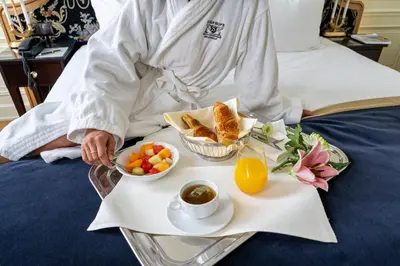 a tray of food with a breakfast on a bed at Stanhope Hotel by Thon Hotels in Brussels