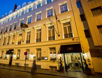 a large building on a city street at night at Stanhope Hotel by Thon Hotels in Brussels