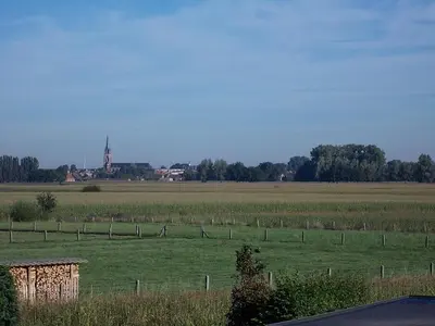a field with a fence in the middle of a field at Het Zolderhuis in Arendonk