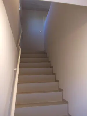 a staircase in a house with a blue light at Het Zolderhuis in Arendonk