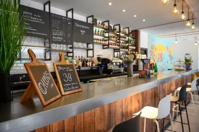 a counter in a restaurant with a sign on it at Tulip Inn Antwerpen in Antwerp