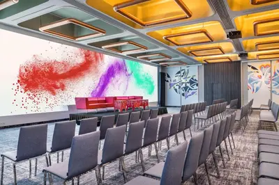 a conference room with chairs and a projection screen at nhow Brussels Bloom in Brussels