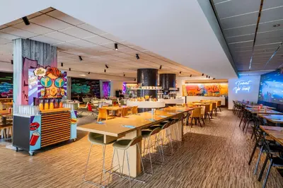 a dining room with tables and chairs and a restaurant at nhow Brussels Bloom in Brussels