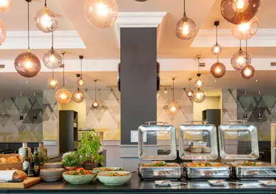 a buffet of food on a counter in a kitchen at Crowne Plaza Antwerpen by IHG in Antwerp