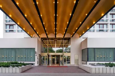 a large building with a large ceiling with lights at Crowne Plaza Antwerpen by IHG in Antwerp
