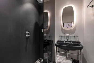 a bathroom with a black sink and a mirror at Hotel Groenendaal in Hoeilaart
