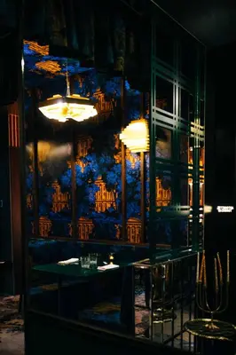 a dining room with a table and a blue wall at Hotel Groenendaal in Hoeilaart