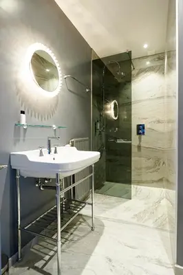 a bathroom with a sink and a shower at Hotel Groenendaal in Hoeilaart