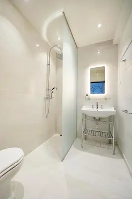 a white bathroom with a sink and a toilet at Hotel Groenendaal in Hoeilaart