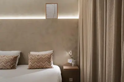 a hotel room with a bed with two pillows at Hotel Astoria Gent in Ghent