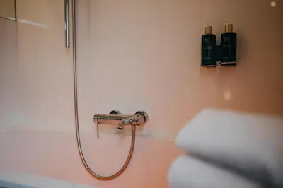 a bathroom with a shower with a shower head at Hotel Astoria Gent in Ghent