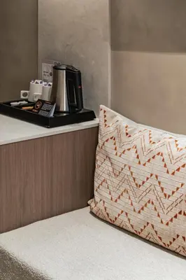 a counter with a coffee maker and a pillow on it at Hotel Astoria Gent in Ghent