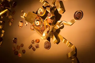 a bunch of gold items are flying in the air at Hotel The Neufchatel in Brussels