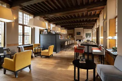 a restaurant with tables and chairs and a bar at Martin's Klooster in Leuven