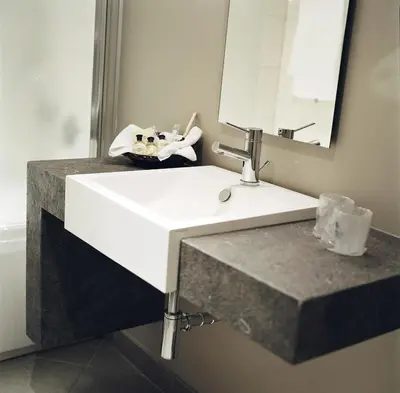 a bathroom with a white sink and a mirror at Martin's Klooster in Leuven