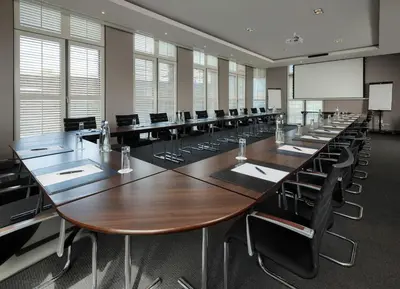 a large conference room with a long table and chairs at Martin's Klooster in Leuven