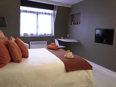 a bedroom with a large white bed with a window at B&B Be In Brussels in Brussels