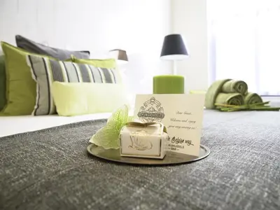 a plate with a box on top of a bed at B&B Be In Brussels in Brussels