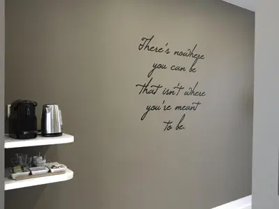 a wall with a quote on it in a kitchen at B&B Be In Brussels in Brussels