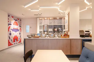 a kitchen with a counter with a counter top at Holiday Inn Express & Suites Ghent by IHG in Ghent