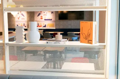 a white shelf with vases and a box on it at Holiday Inn Express & Suites Ghent by IHG in Ghent