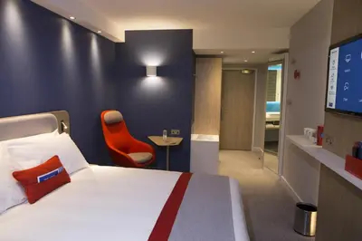 a hotel room with a bed and a tv at Holiday Inn Express & Suites Ghent by IHG in Ghent