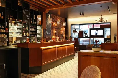 a bar in a restaurant with a counter and a bar sidx sidx at Hotel Van Belle in Brussels