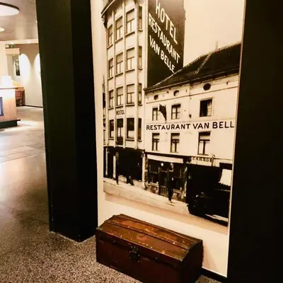 a trunk sitting on the floor next to a picture of a building at Hotel Van Belle in Brussels